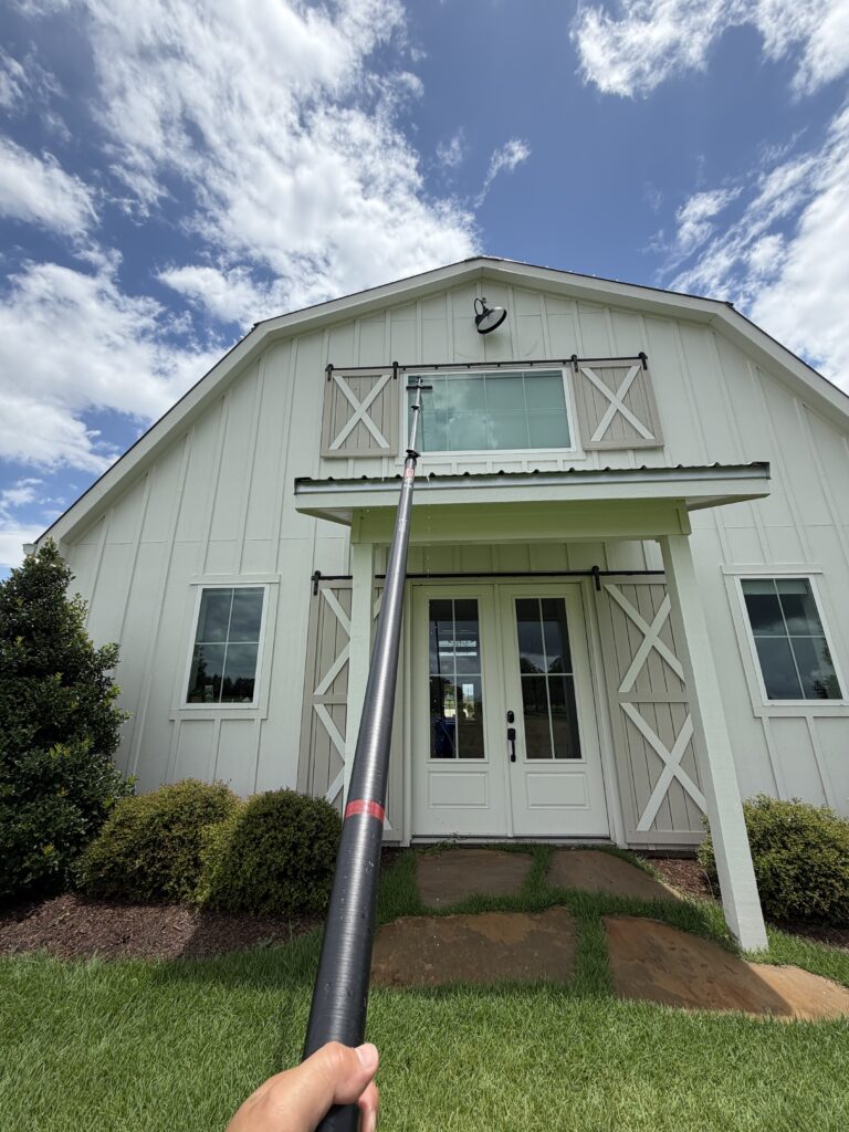 Window cleaning on a barn-style home in Brenham TX