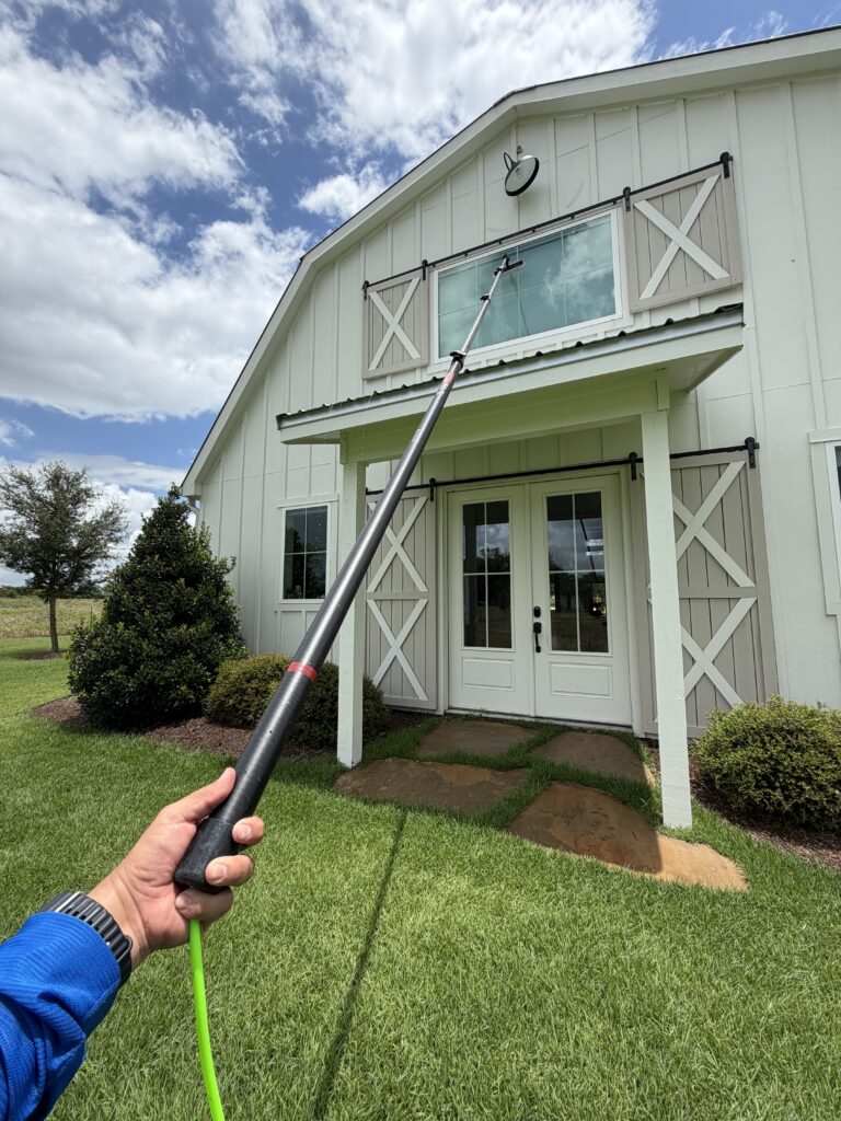 Window cleaning on a barn-style home in Brenham TX