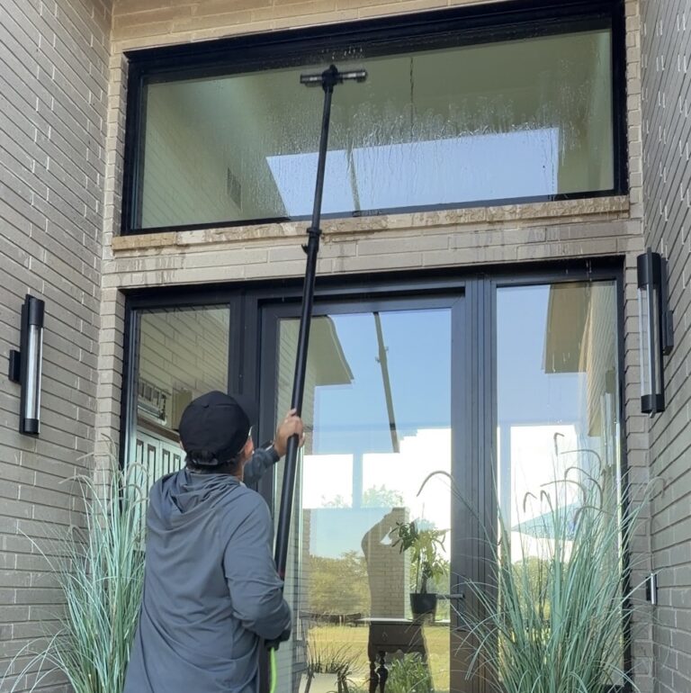 Window cleaning with a water-fed pole on a modern home in Brenham Texas
