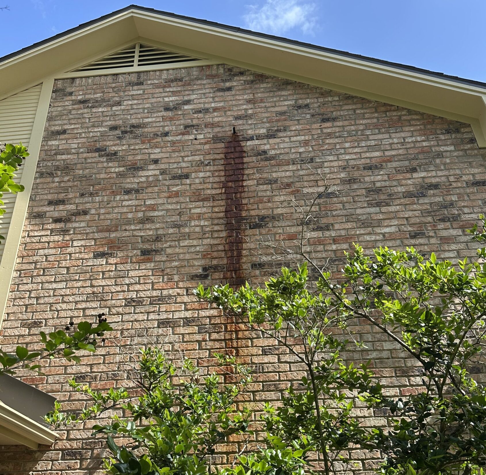 huge rust stain on the side of a house in Bryan Texas