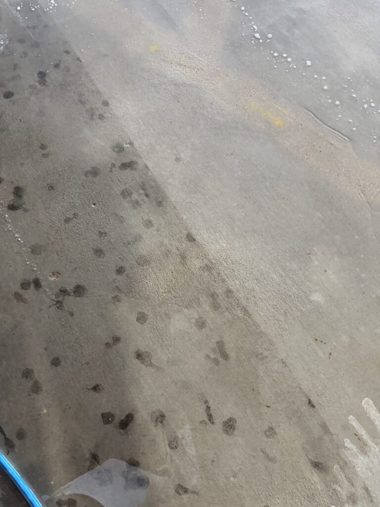 Oil stain removal on a concrete garage floor in Bryan, TX