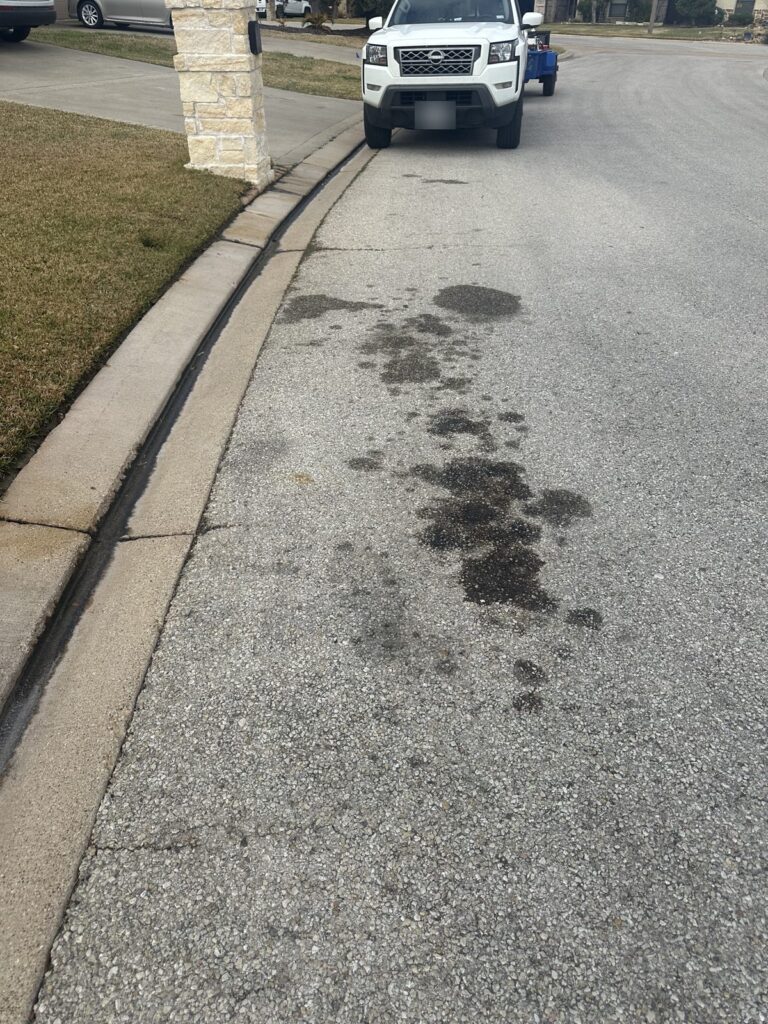 Oil stains on concrete before oil stain removal in Bryan, TX