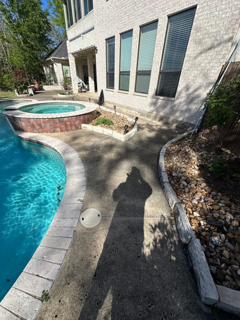 Pool deck before pressure washing in College Station, TX