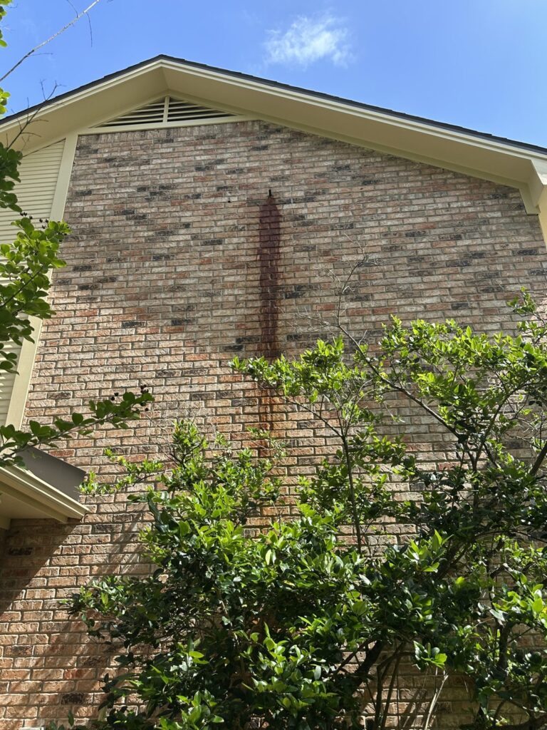 Rust stain on a brick wall before rust removal in Bryan, TX