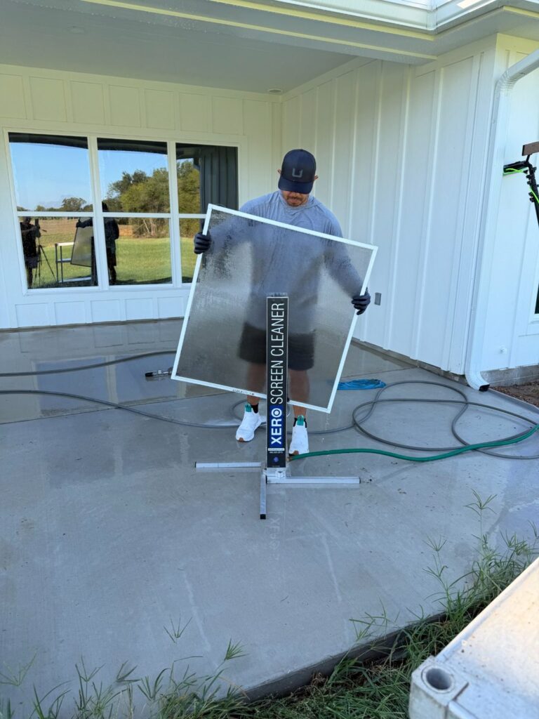 Scrubbing a window screen on a Xero screen cleaner in Bryan, TX